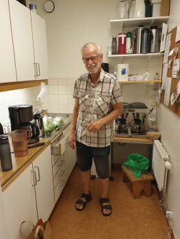 En man som kokar kaffe i ett litet pentry